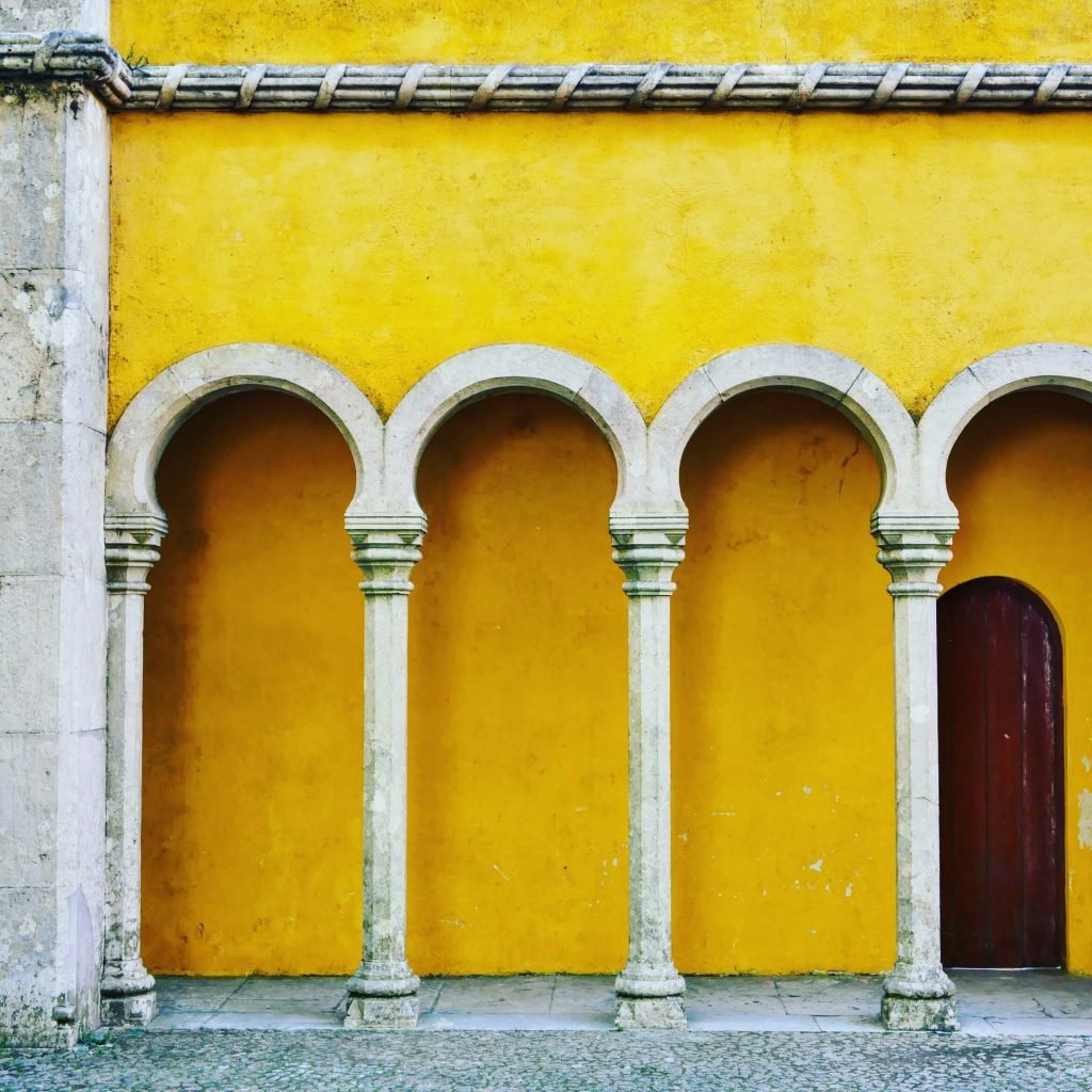 A yellow wall with four pillars in Sintra