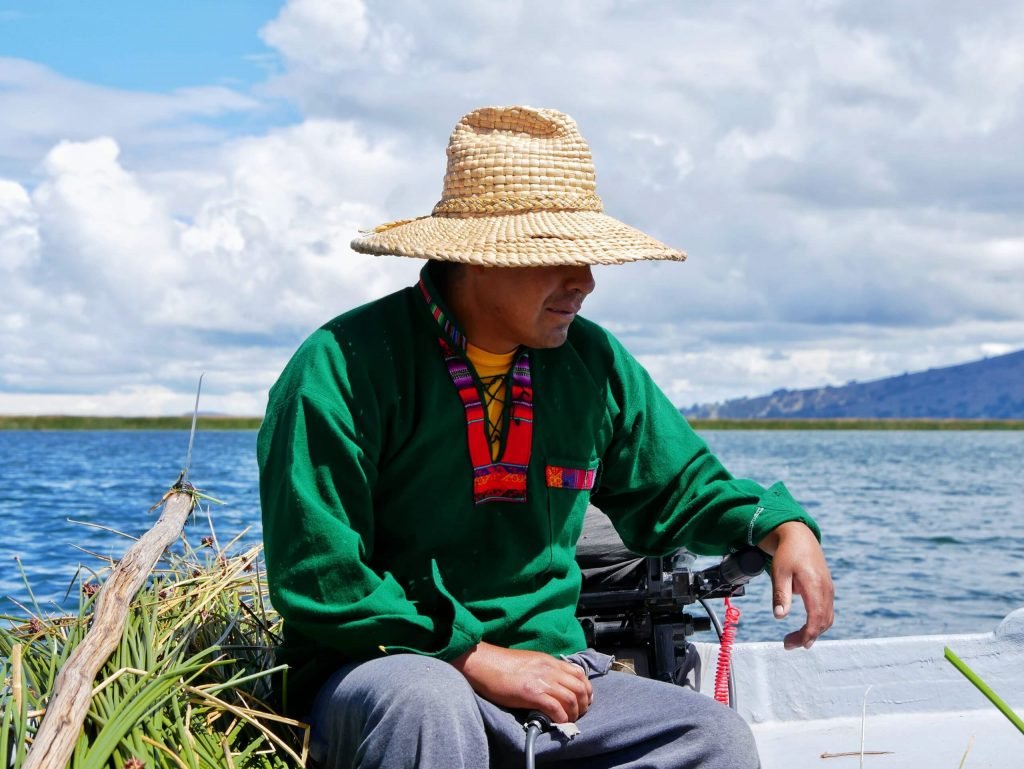 An Uros man on a boat with Totora reed
