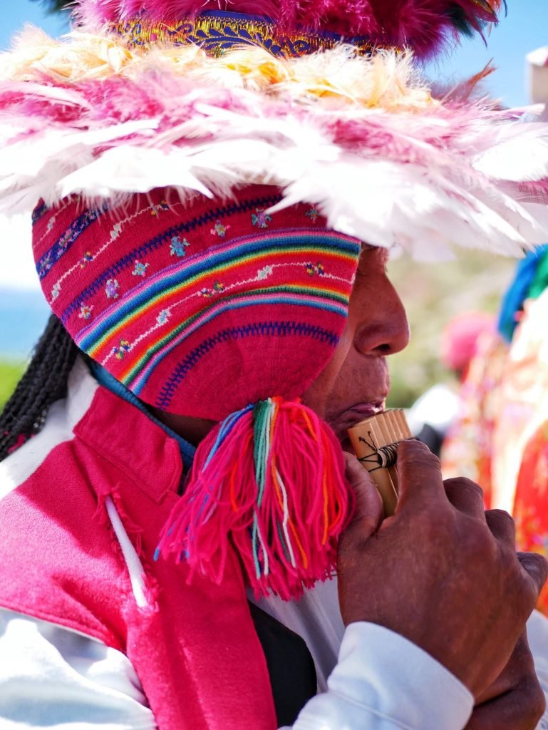 A Taquileño playing on pan flute on Taquile island, Peru