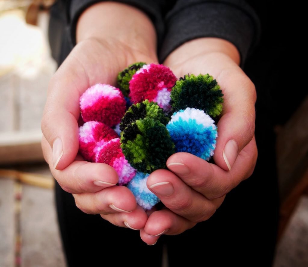 bonbons in hands made of wool