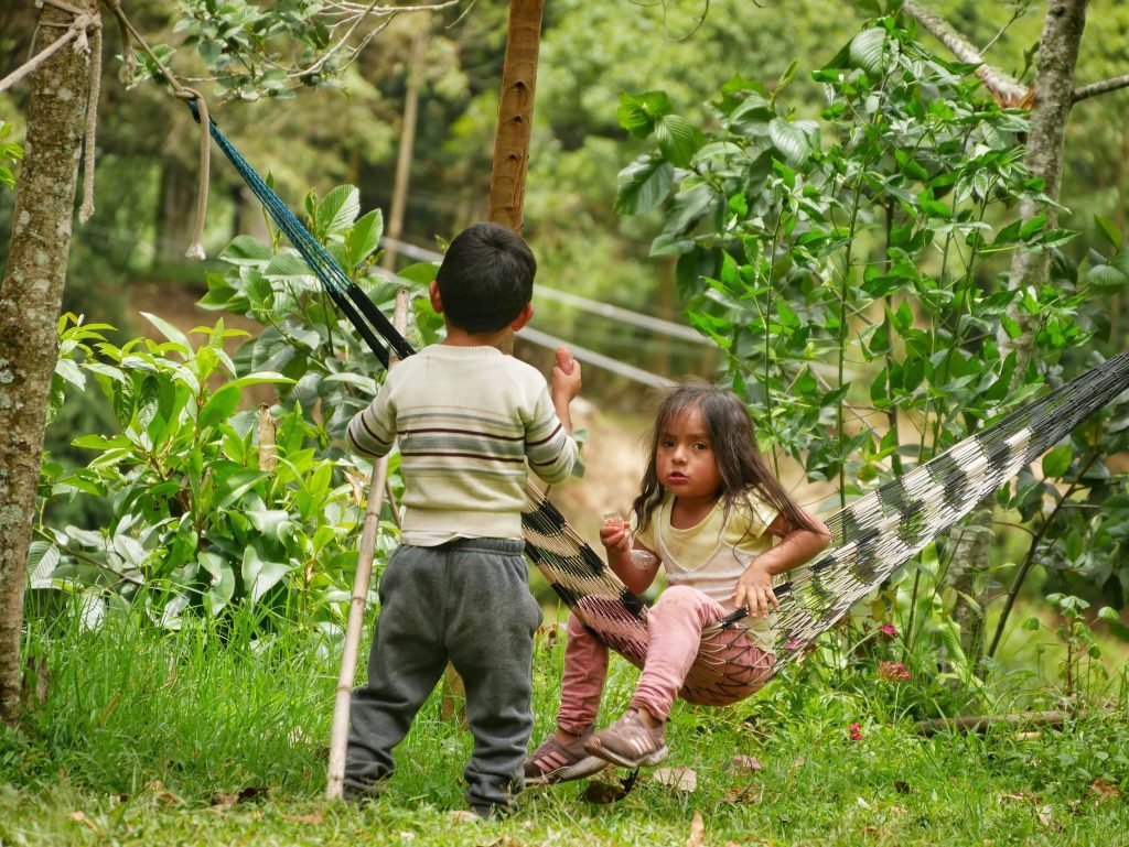 Peruvian kids playing in a hammock