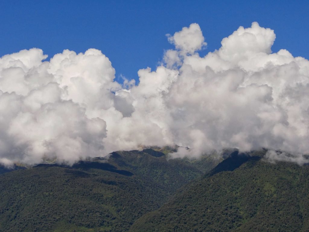 Clounds over green mountains in Peru during Salkantay Trek