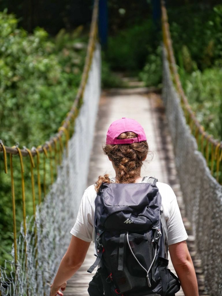 Britta Wiebe hiking on a suspension bridge