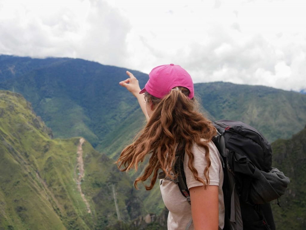 A girl pointing in the sky at Machu Picchu