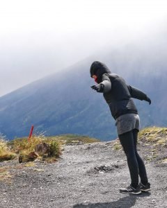 girl standing in wind in windy Patagonia torres del paine