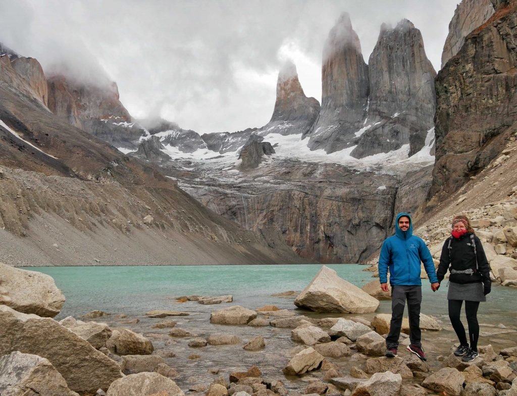 Jamin Mahmood and Britta Wiebe couple standing a viewpoint torres del paine three rocks lake Patagonia