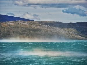 windy lake pehoe breeze dust causing rainbows through the sun