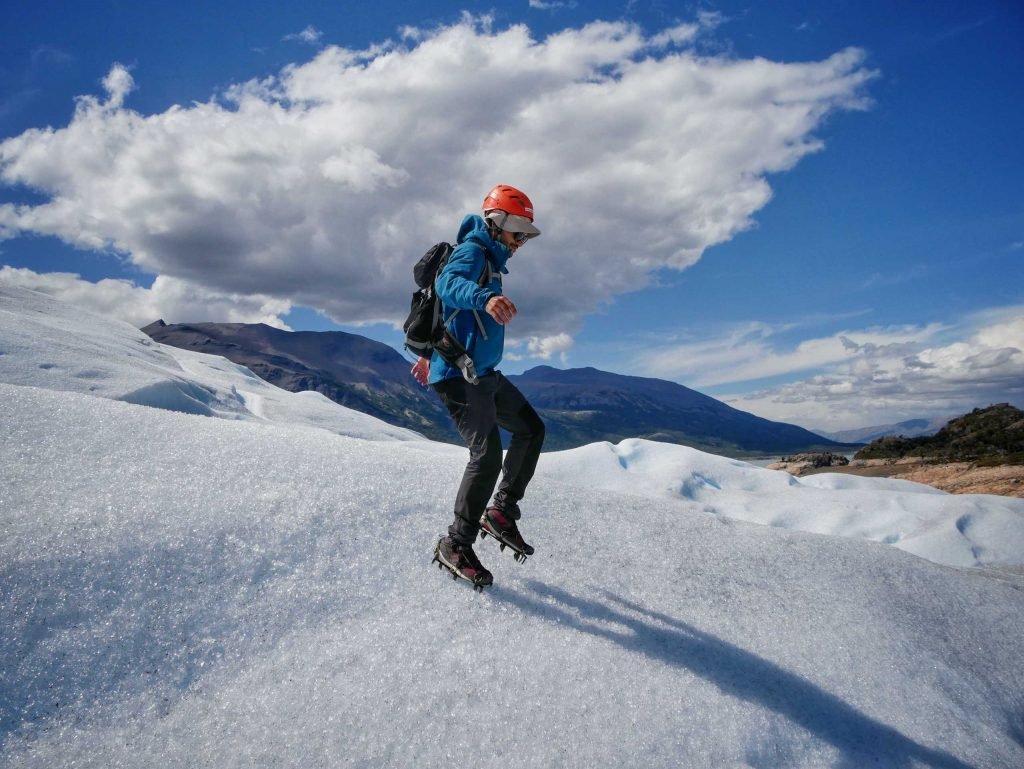 man jumping on glacier