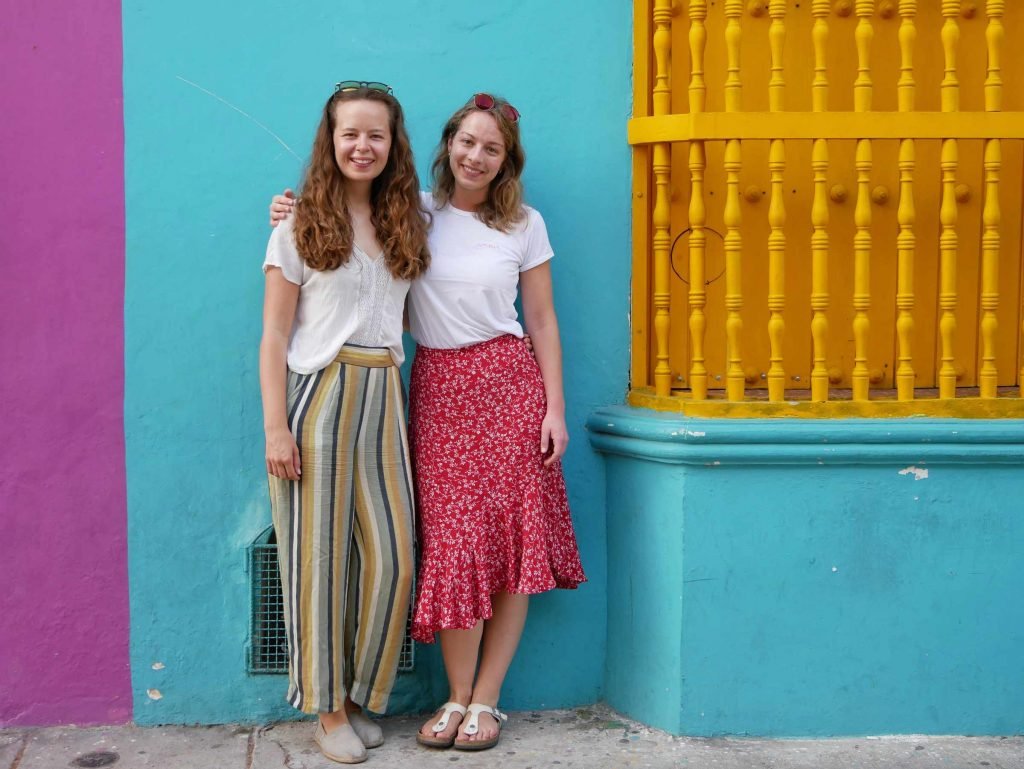colorful walls girls standing Cartagena Colombia