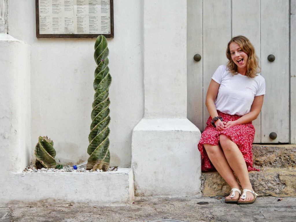 girl sitting on old steps in Cartagena Colombia
