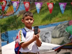 medellin boy holding a smartphone